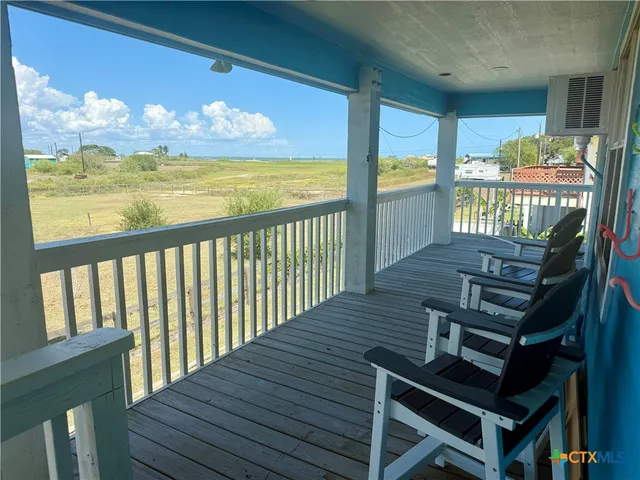 a view of a balcony with wooden floor
