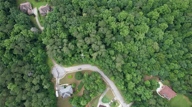 an aerial view of a house with a yard and outdoor seating