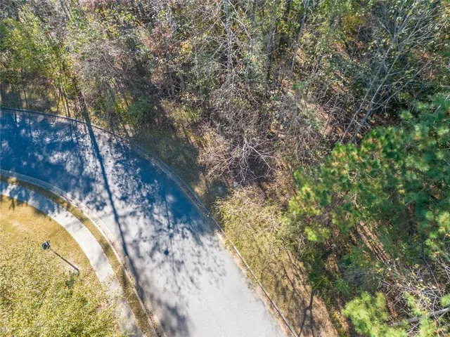 a view of a yard with wooden fence