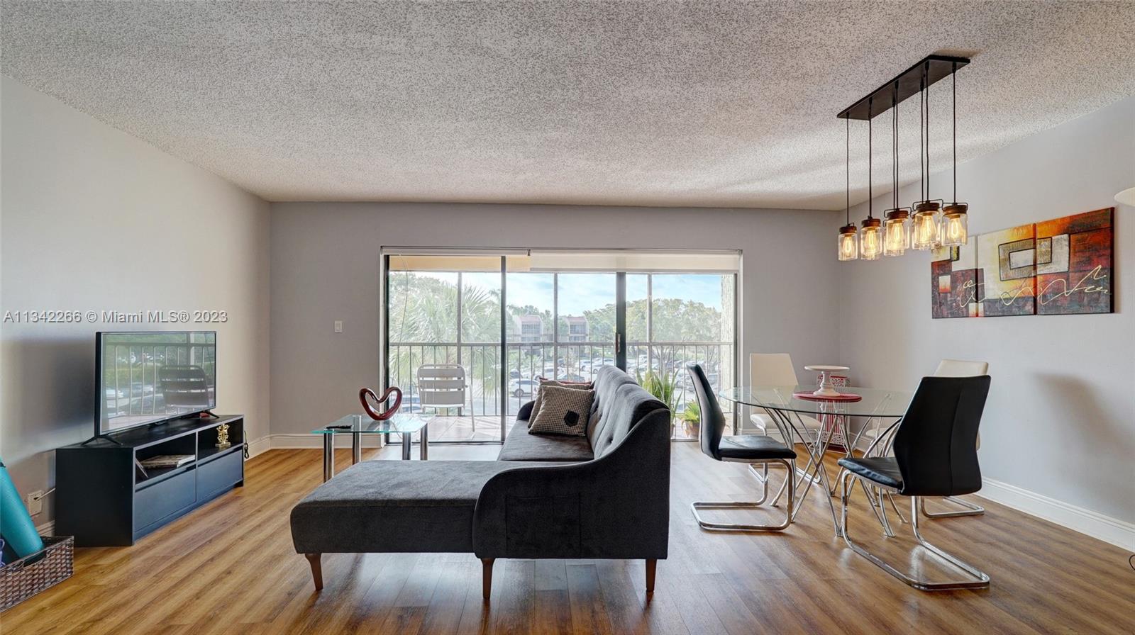 Racquet Club Apartments at Bonaventure Weston, FL 33326 - Photo 1 of 26 a view of a dining room with furniture window and wooden floor