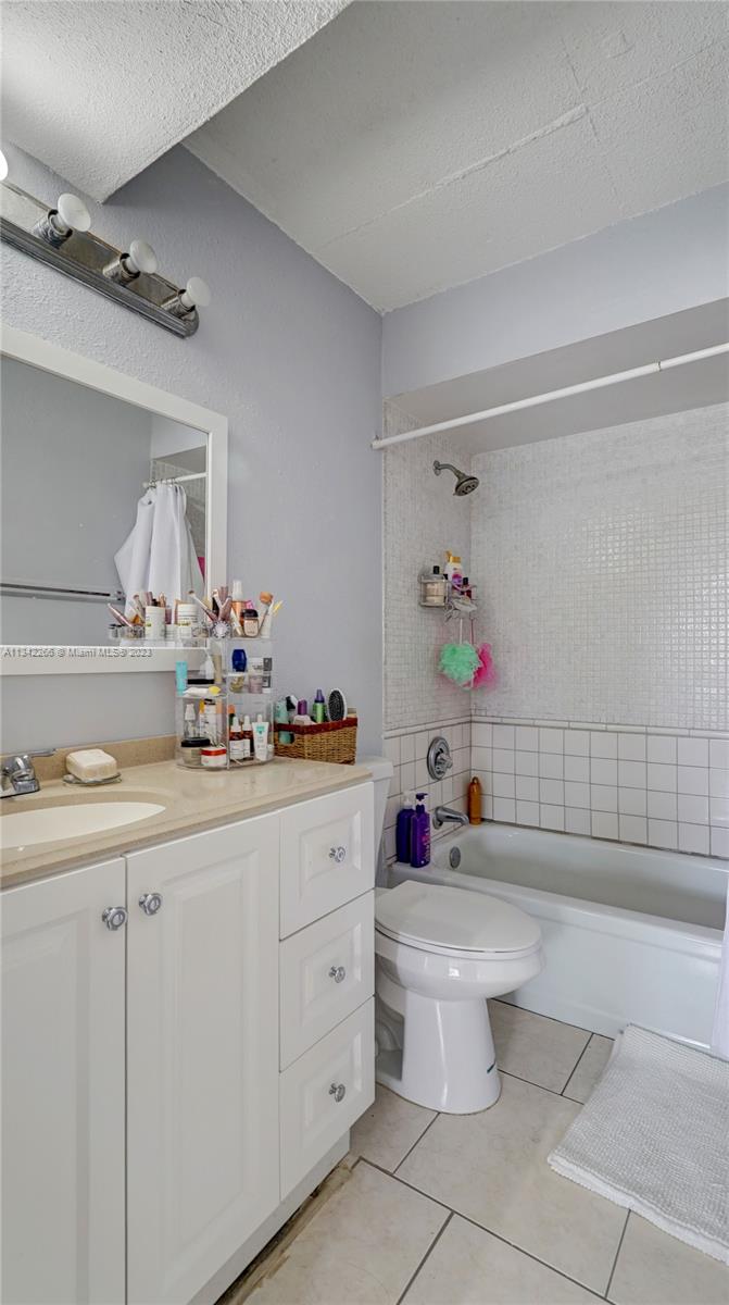 Racquet Club Apartments at Bonaventure Weston, FL 33326 - Photo 14 of 26 a bathroom with a sink vanity mirror and toilet