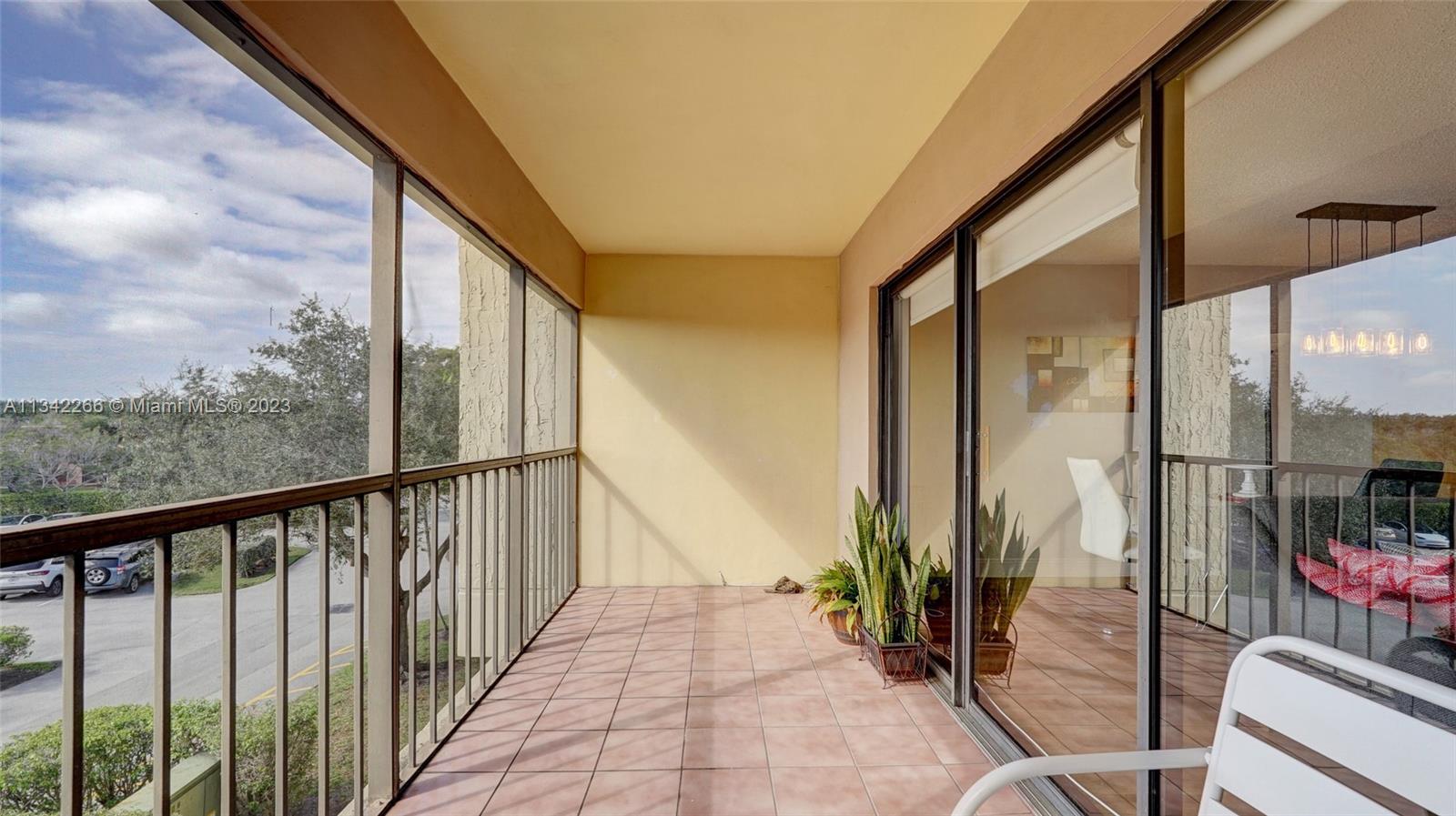 Racquet Club Apartments at Bonaventure Weston, FL 33326 - Photo 18 of 26 a view of a balcony with chairs