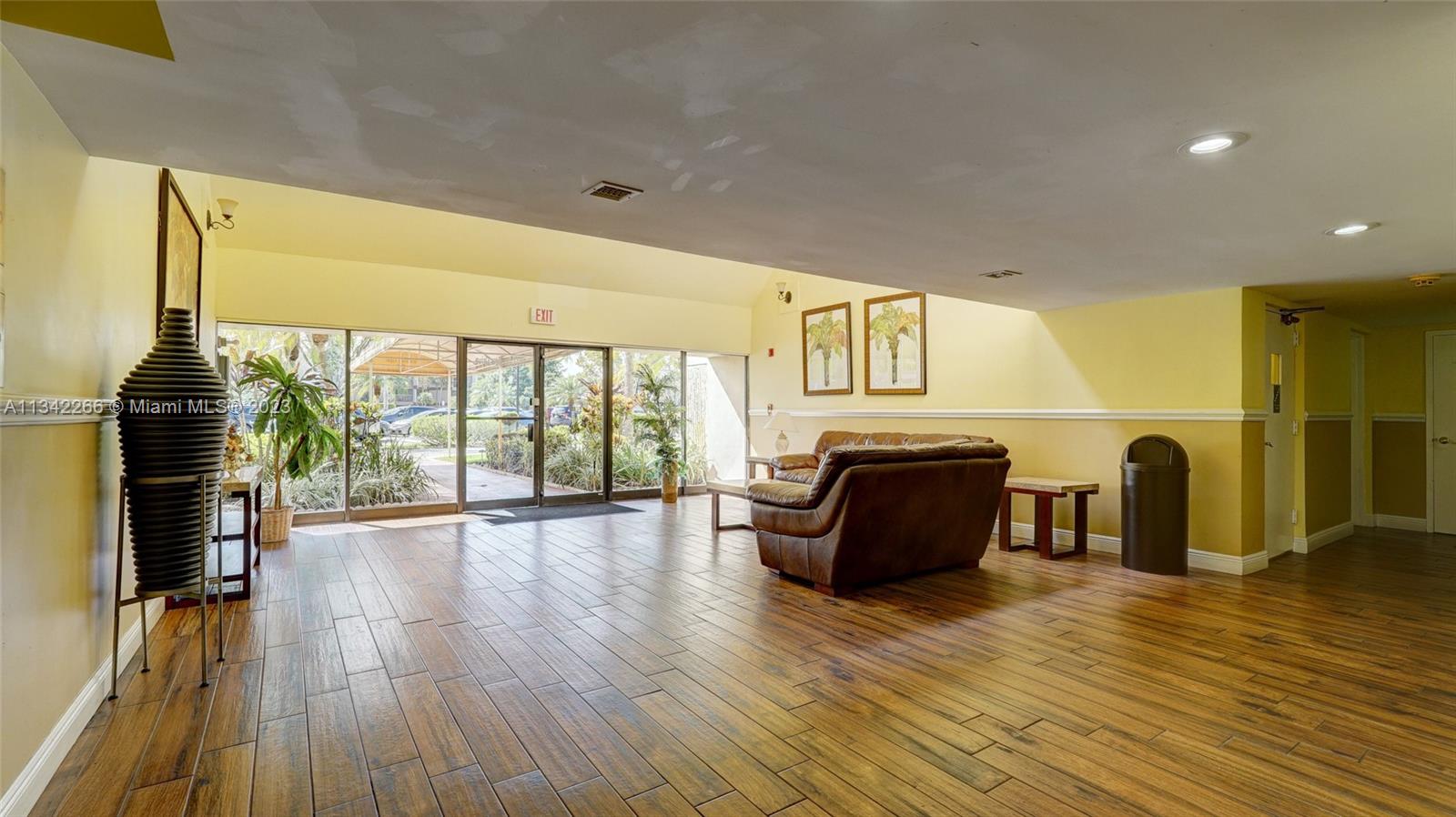 Racquet Club Apartments at Bonaventure Weston, FL 33326 - Photo 19 of 26 a living room with furniture and wooden floor