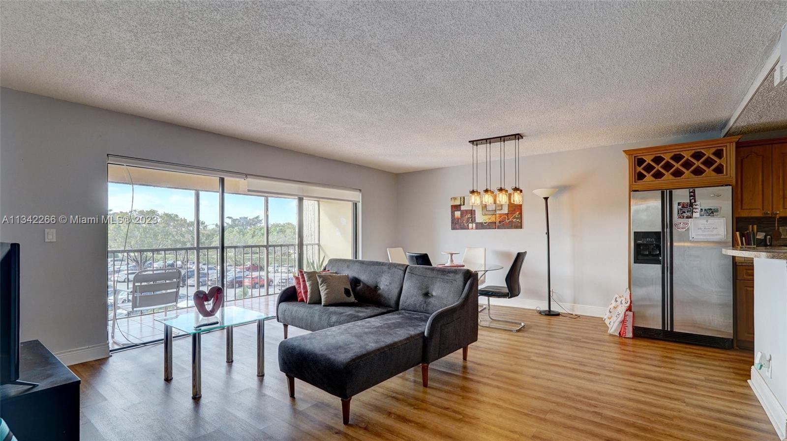 Racquet Club Apartments at Bonaventure Weston, FL 33326 - Photo 2 of 26 a living room with furniture and a large window