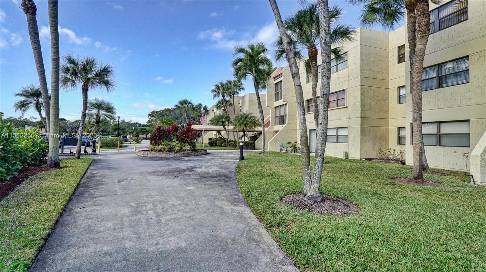 Racquet Club Apartments at Bonaventure Weston, FL 33326 - Photo 23 of 26 a view of a street with palm trees
