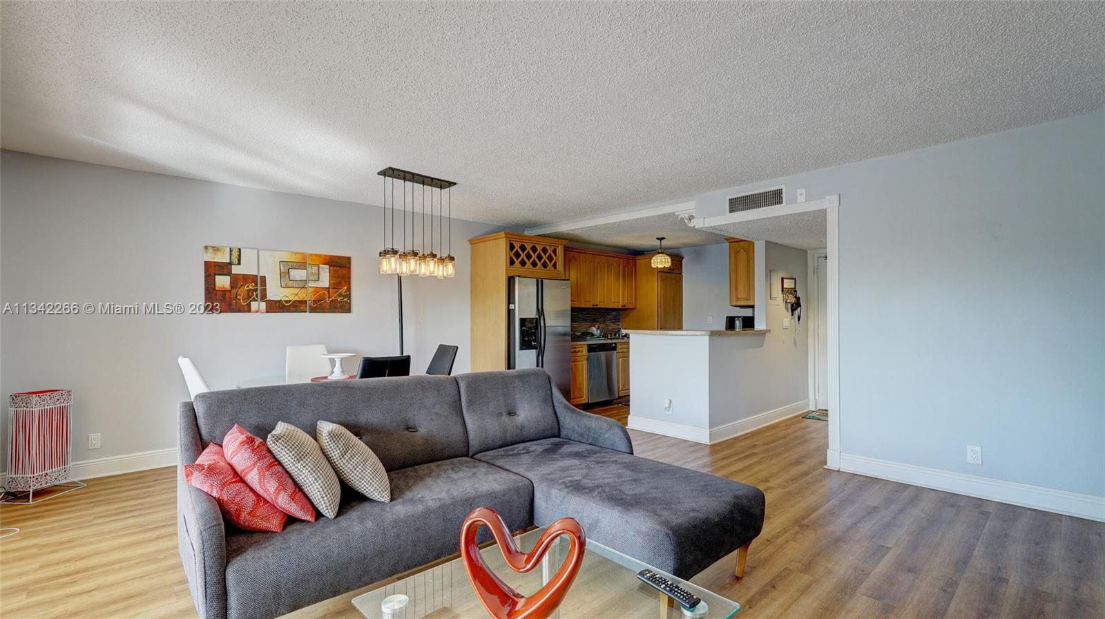 Racquet Club Apartments at Bonaventure Weston, FL 33326 - Photo 3 of 26 a living room with furniture and wooden floor