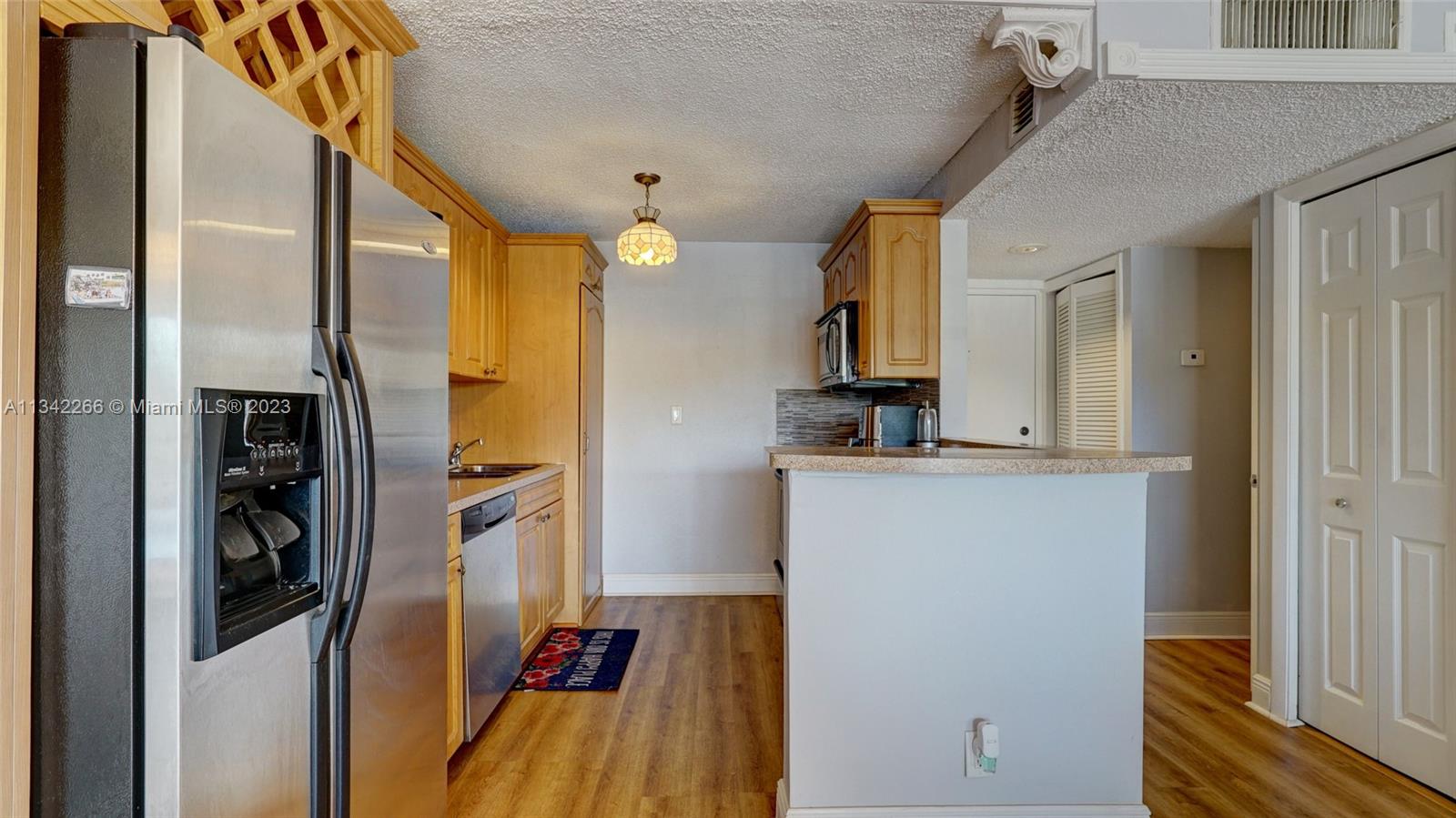 Racquet Club Apartments at Bonaventure Weston, FL 33326 - Photo 5 of 26 a view of a kitchen from a hallway