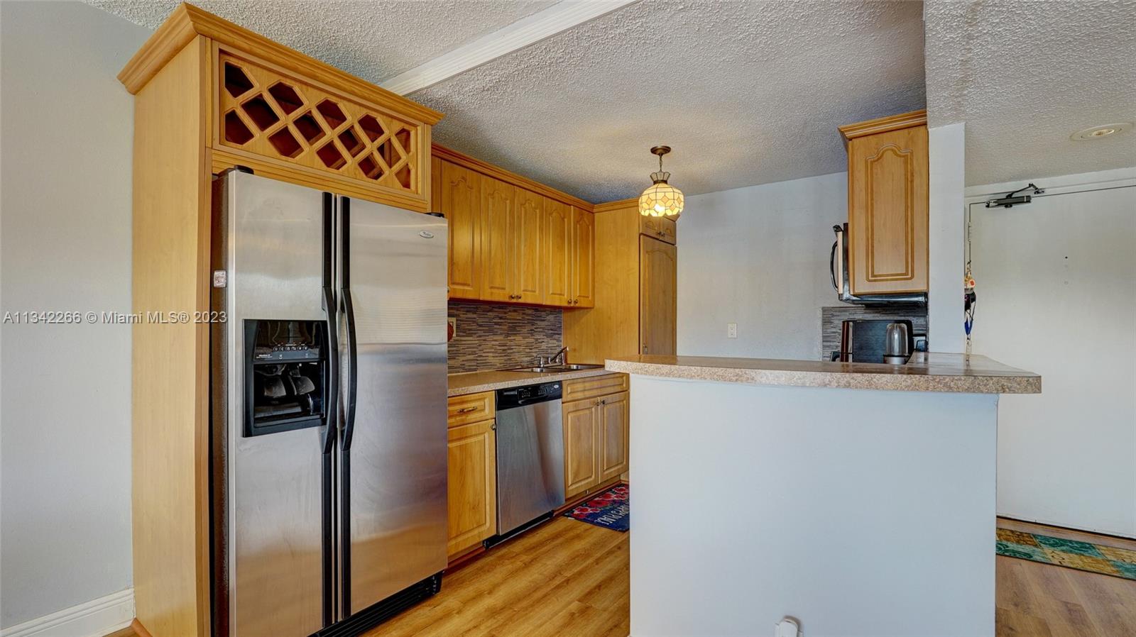 Racquet Club Apartments at Bonaventure Weston, FL 33326 - Photo 6 of 26 a kitchen with stainless steel appliances granite countertop a refrigerator and a stove