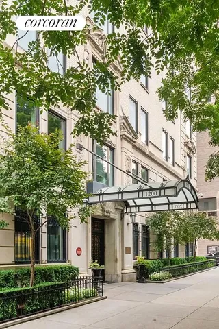 a front view of a building with a tree