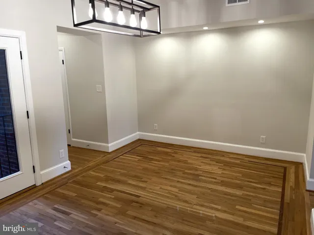 a view of a room with wooden floor