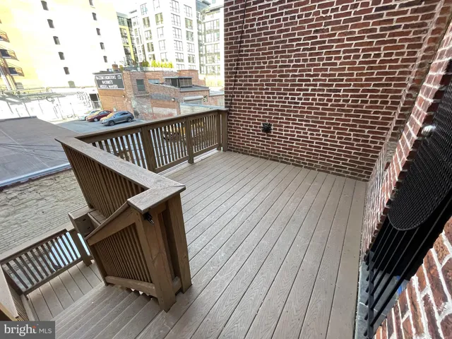 a view of balcony with wooden floor