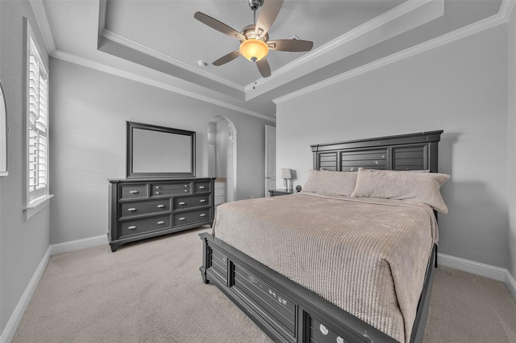 1060 Waters Edge Court Oak Point, TX 75068 - Photo 14 of 40 a bedroom with a bed and a dresser