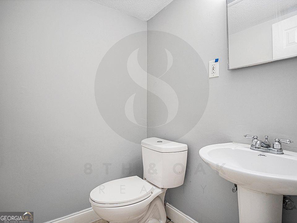 4701 Flat Shoals Road, Unit 59B Union City, GA 30291 - Photo 2 of 9 a white toilet sitting next to a white sink