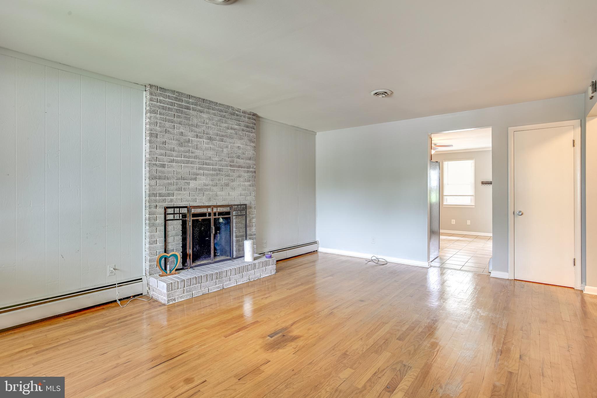 312 Savannah Road Baltimore, MD 21221 - Photo 4 of 29 Living Room w/ Brick Surround Wood Fireplace