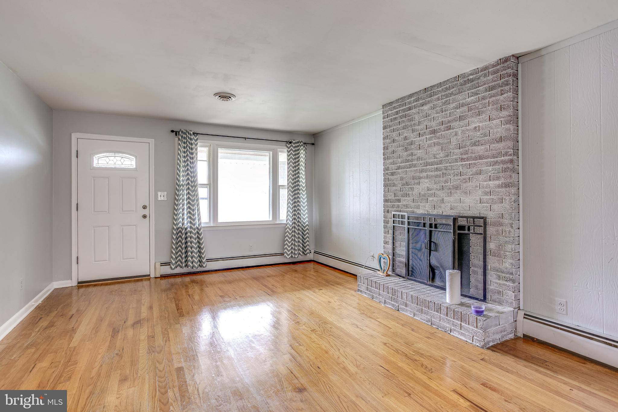 312 Savannah Road Baltimore, MD 21221 - Photo 6 of 29 Living Room w/ Brick Surround Wood Fireplace
