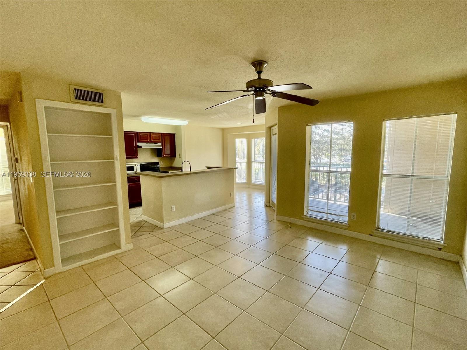 977 Riverside Drive, Unit 227 Coral Springs, FL 33071 - Photo 15 of 36 a view of a kitchen with furniture and a refrigerator