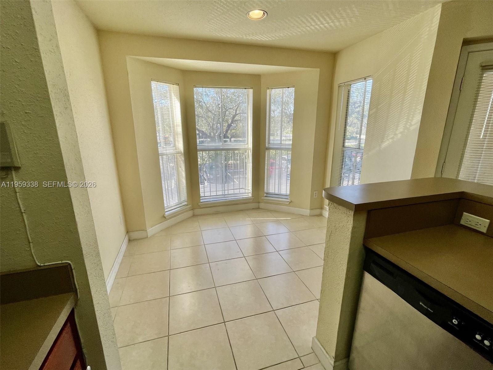 977 Riverside Drive, Unit 227 Coral Springs, FL 33071 - Photo 19 of 36 a view of an empty room with a window