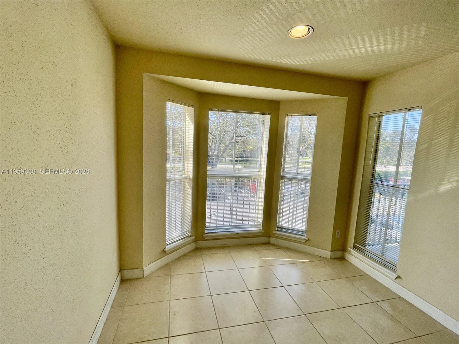 977 Riverside Drive, Unit 227 Coral Springs, FL 33071 - Photo 20 of 36 a view of an empty room with a fireplace and a window