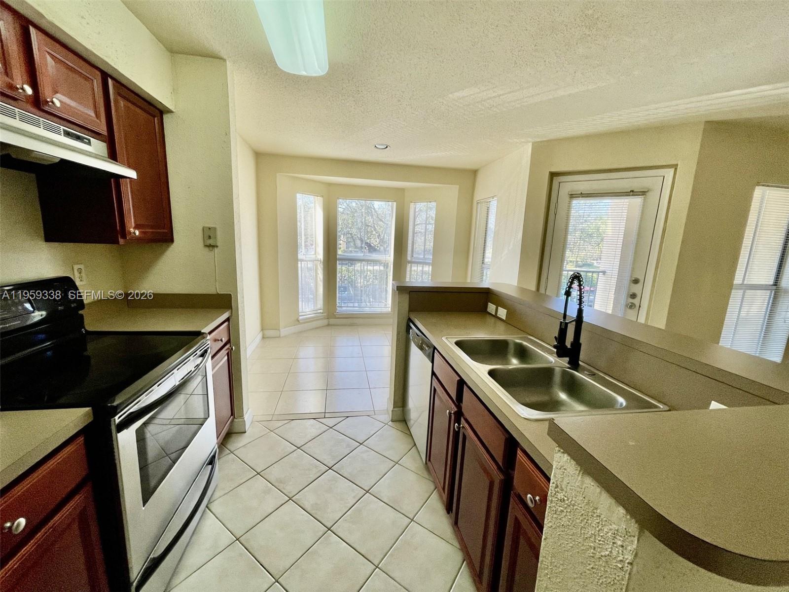 977 Riverside Drive, Unit 227 Coral Springs, FL 33071 - Photo 22 of 36 a kitchen that has a sink and a stove