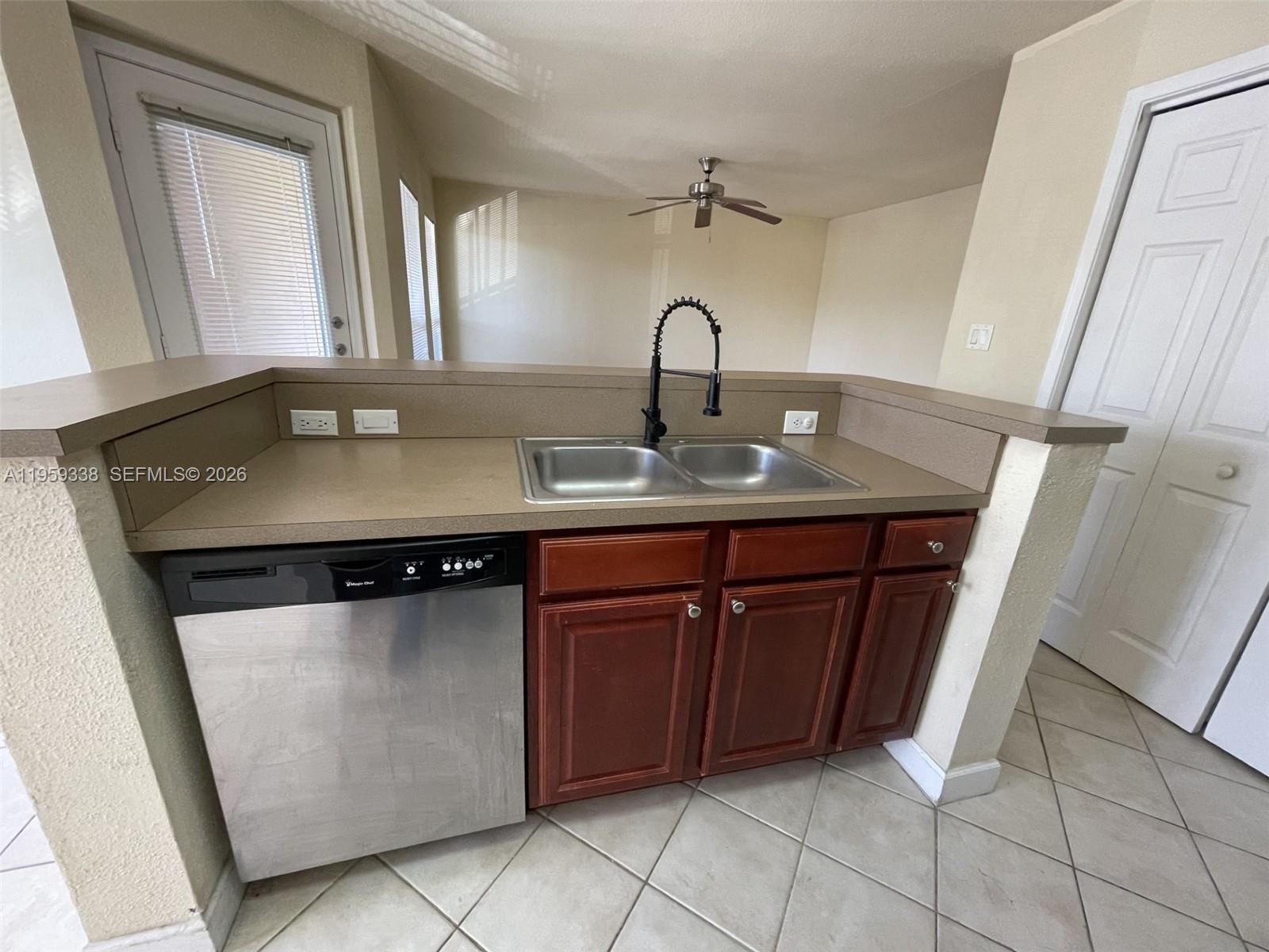 977 Riverside Drive, Unit 227 Coral Springs, FL 33071 - Photo 25 of 36 a close view of a sink a counter space and a light fixture in the kitchen