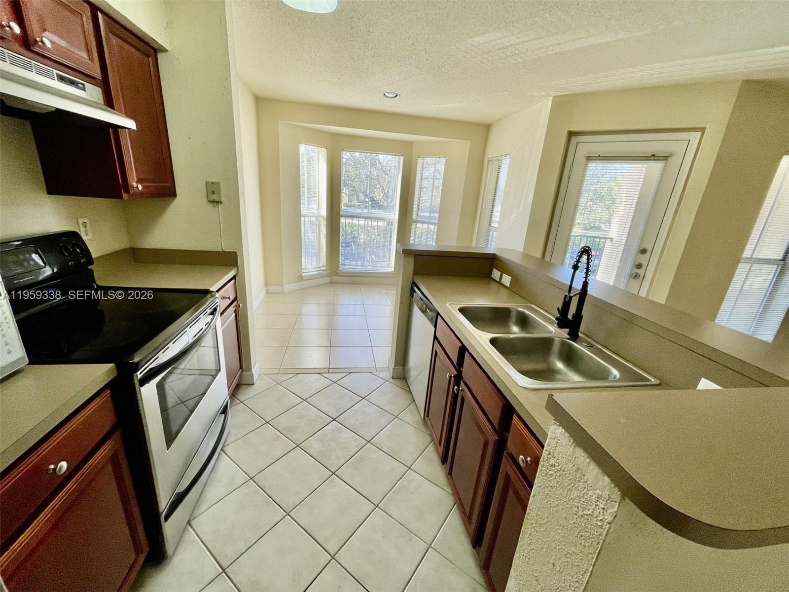 977 Riverside Drive, Unit 227 Coral Springs, FL 33071 - Photo 3 of 36 a kitchen that has a sink and a stove