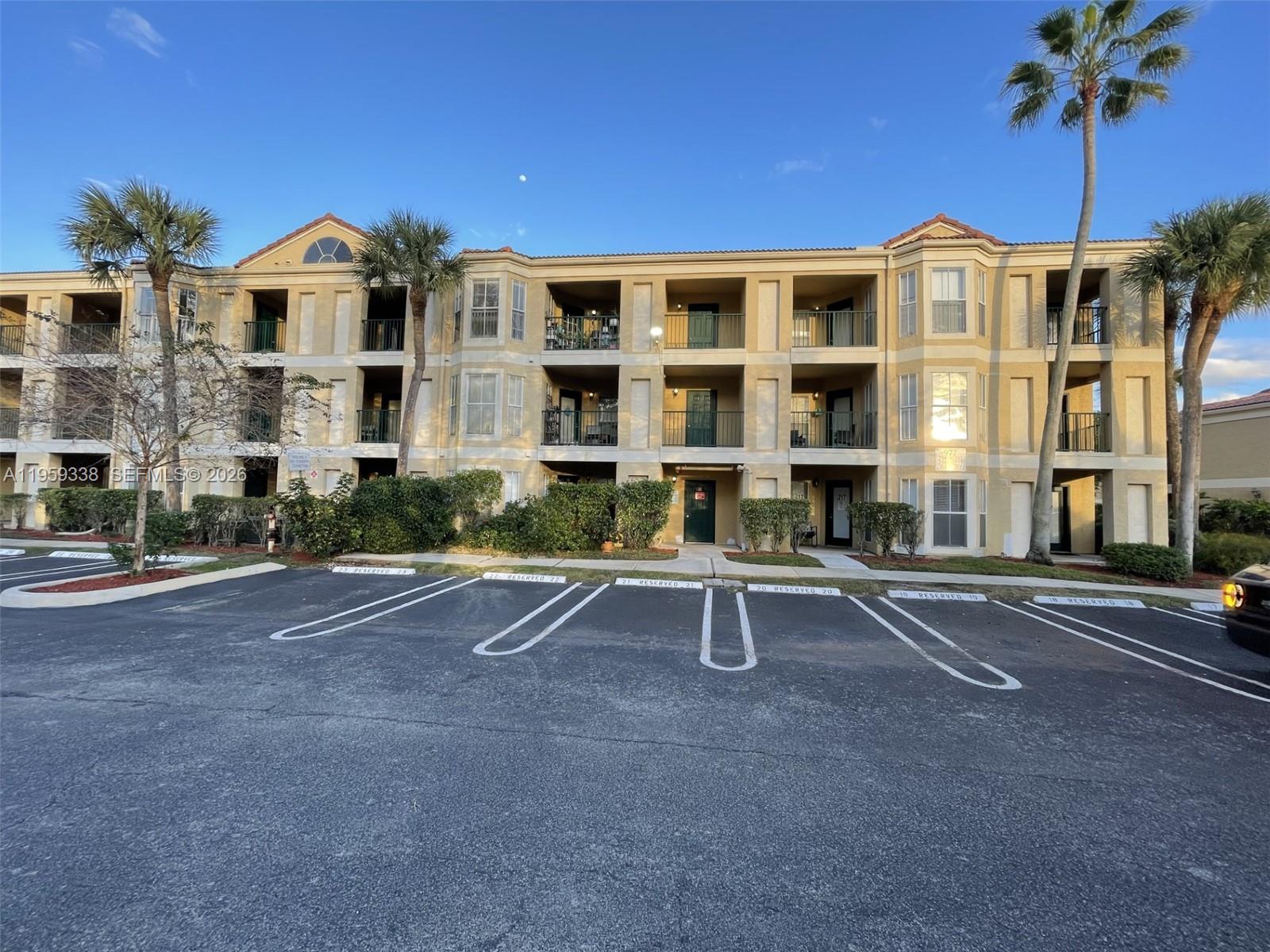 977 Riverside Drive, Unit 227 Coral Springs, FL 33071 - Photo 32 of 36 a front view of building with a yard