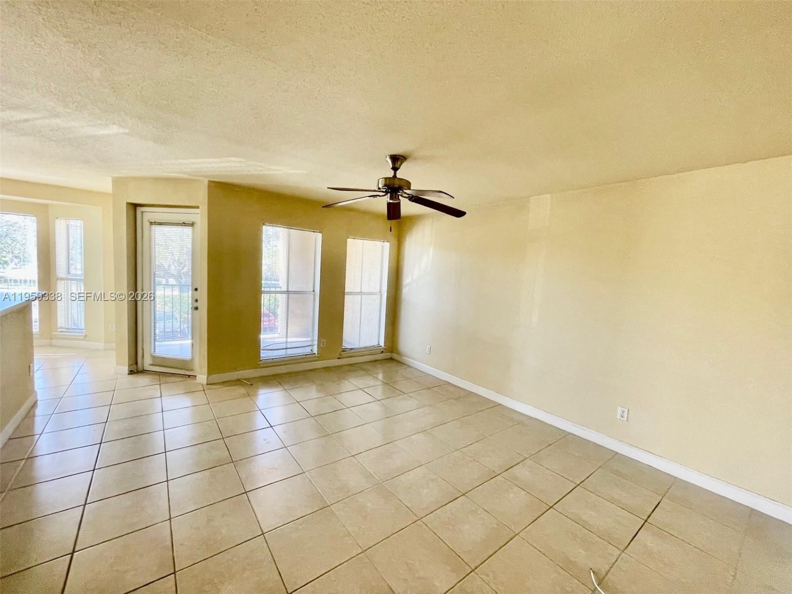 977 Riverside Drive, Unit 227 Coral Springs, FL 33071 - Photo 6 of 36 a view of an empty room with glass door
