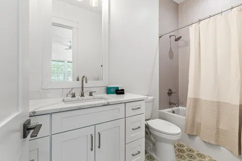 a living room with furniture a table and a potted plant