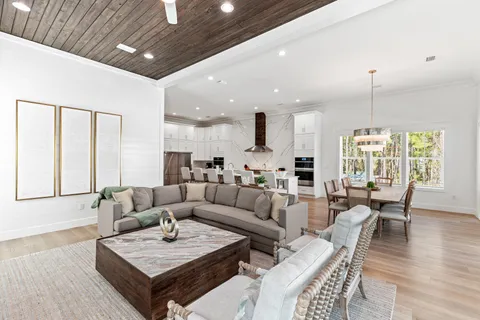 a kitchen with a stove and a wooden floor