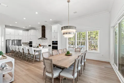 a kitchen with stainless steel appliances kitchen island granite countertop a sink and wooden floors