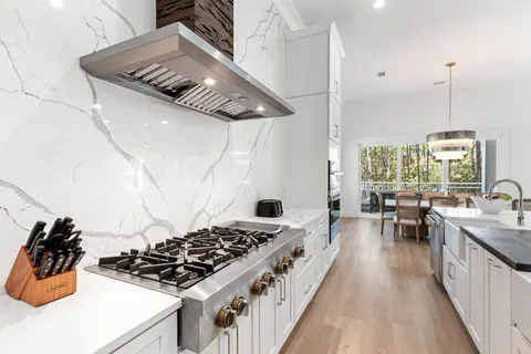 a kitchen with stainless steel appliances granite countertop a sink and a refrigerator
