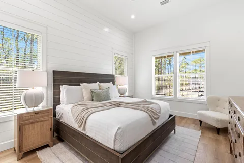 a bedroom with a large bed and a window