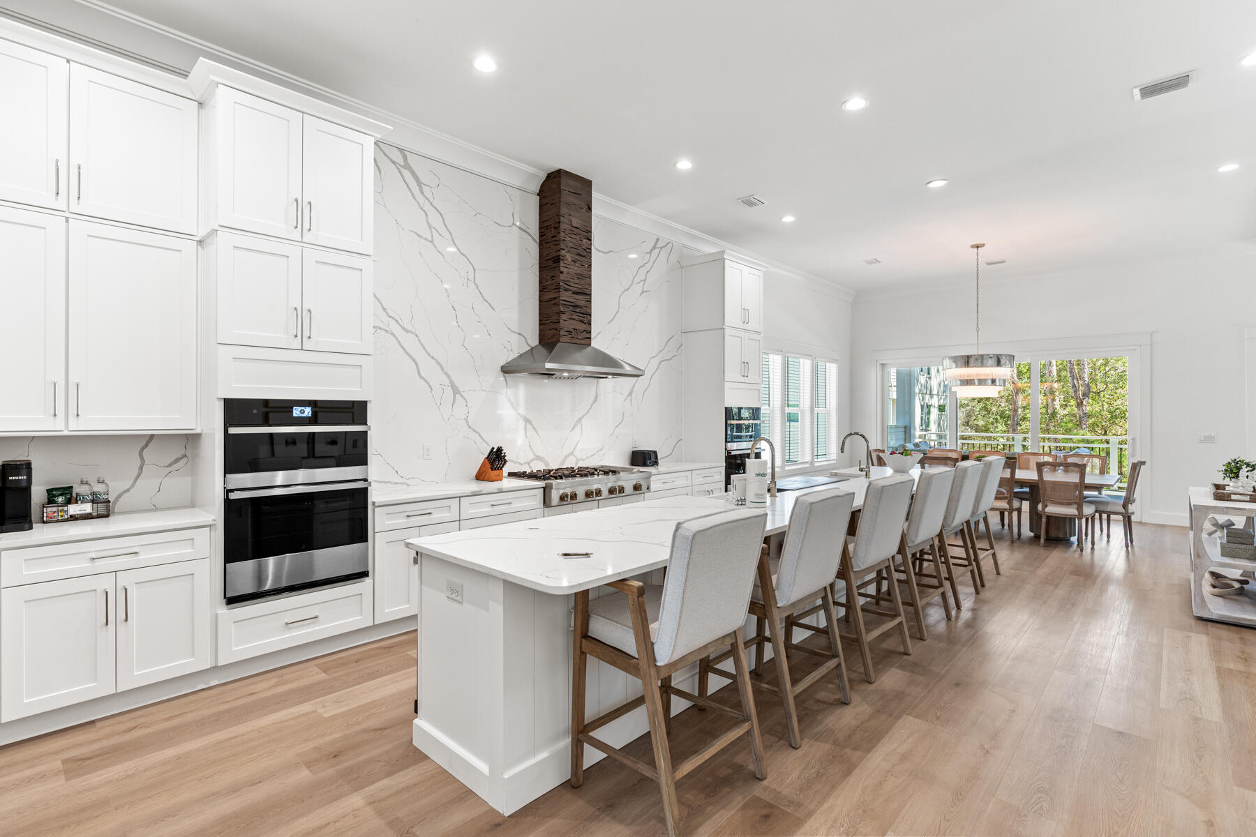 74 Shady Pines Drive Santa Rosa Beach, FL 32459 - Photo 3 of 51 a kitchen with stainless steel appliances a stove a sink a kitchen island with a dining table and chairs