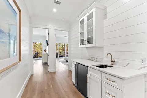 a spacious bathroom with double sink a toilet a large mirror and shower