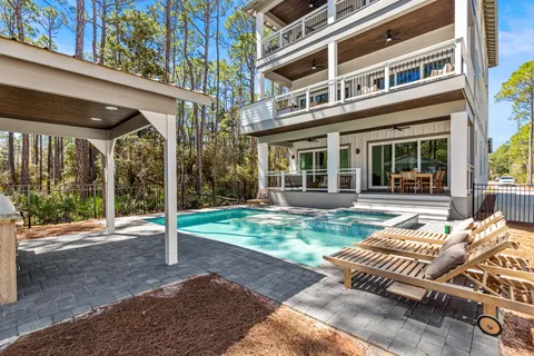 a backyard of a house with garden and outdoor seating