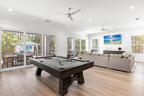 a living room with furniture a large window and a table
