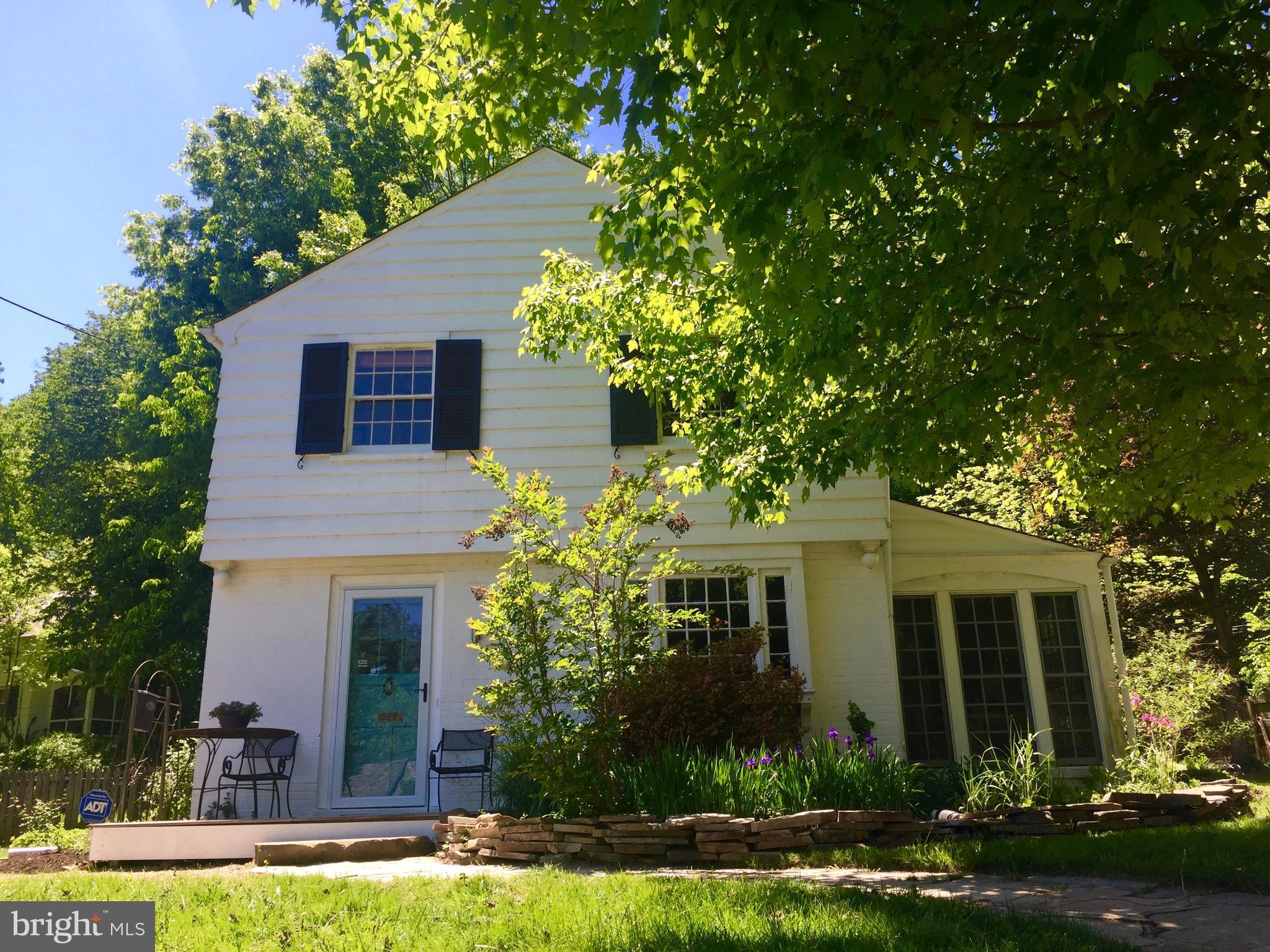 2444 Pickwick Road Baltimore, MD 21207 - Photo 13 of 24 a front view of a house with a garden and plants
