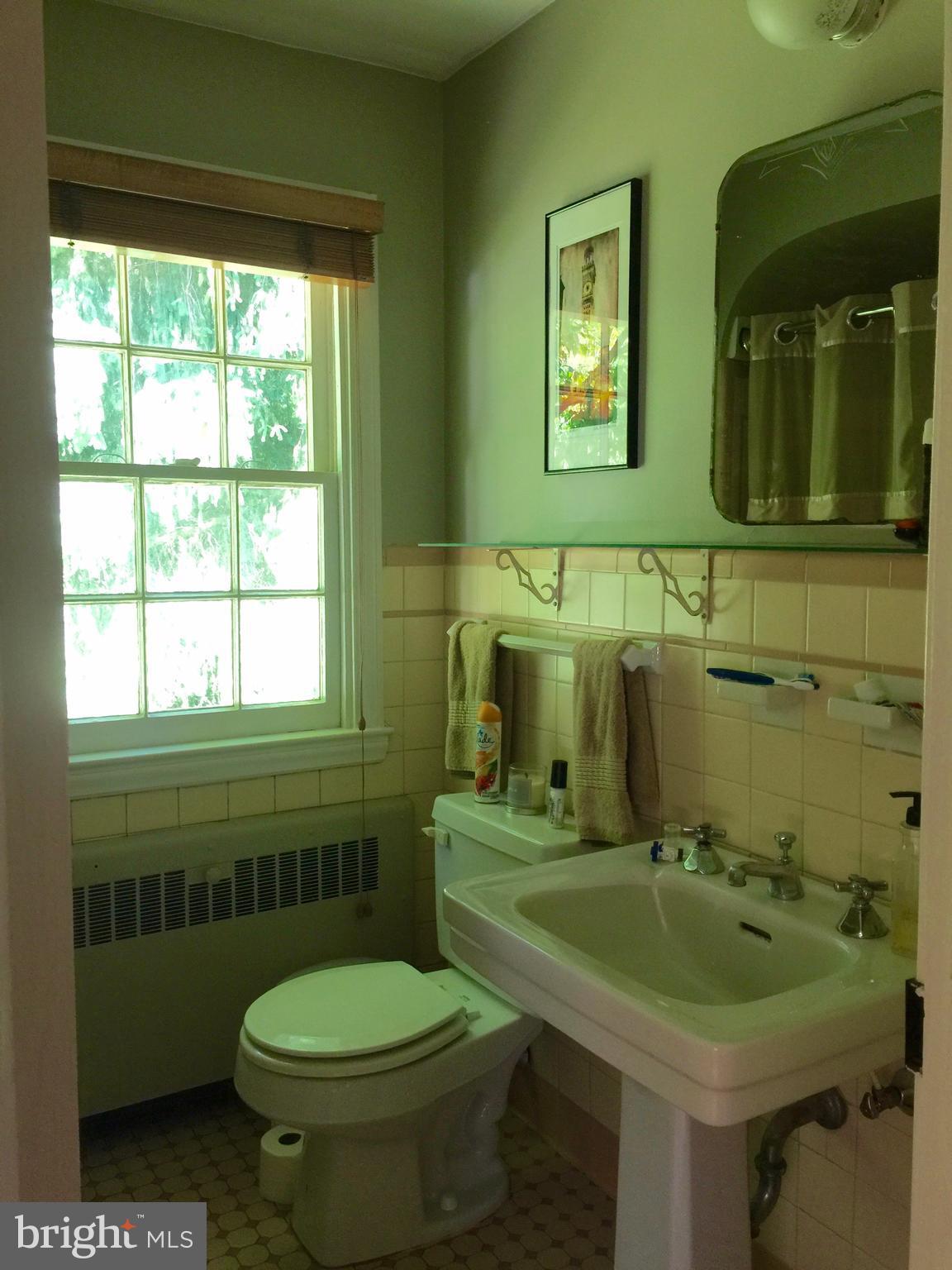 2444 Pickwick Road Baltimore, MD 21207 - Photo 14 of 24 a bathroom with a sink toilet and mirror
