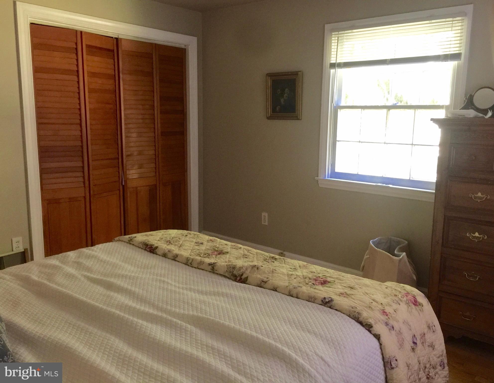 2444 Pickwick Road Baltimore, MD 21207 - Photo 15 of 24 a bedroom with a bed and a window