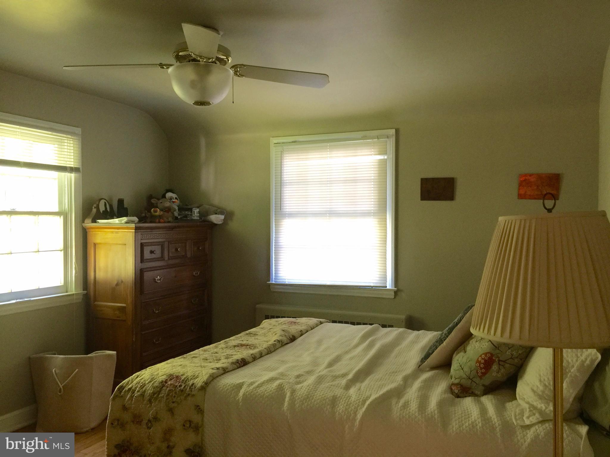 2444 Pickwick Road Baltimore, MD 21207 - Photo 16 of 24 a bedroom with a bed dresser and a window