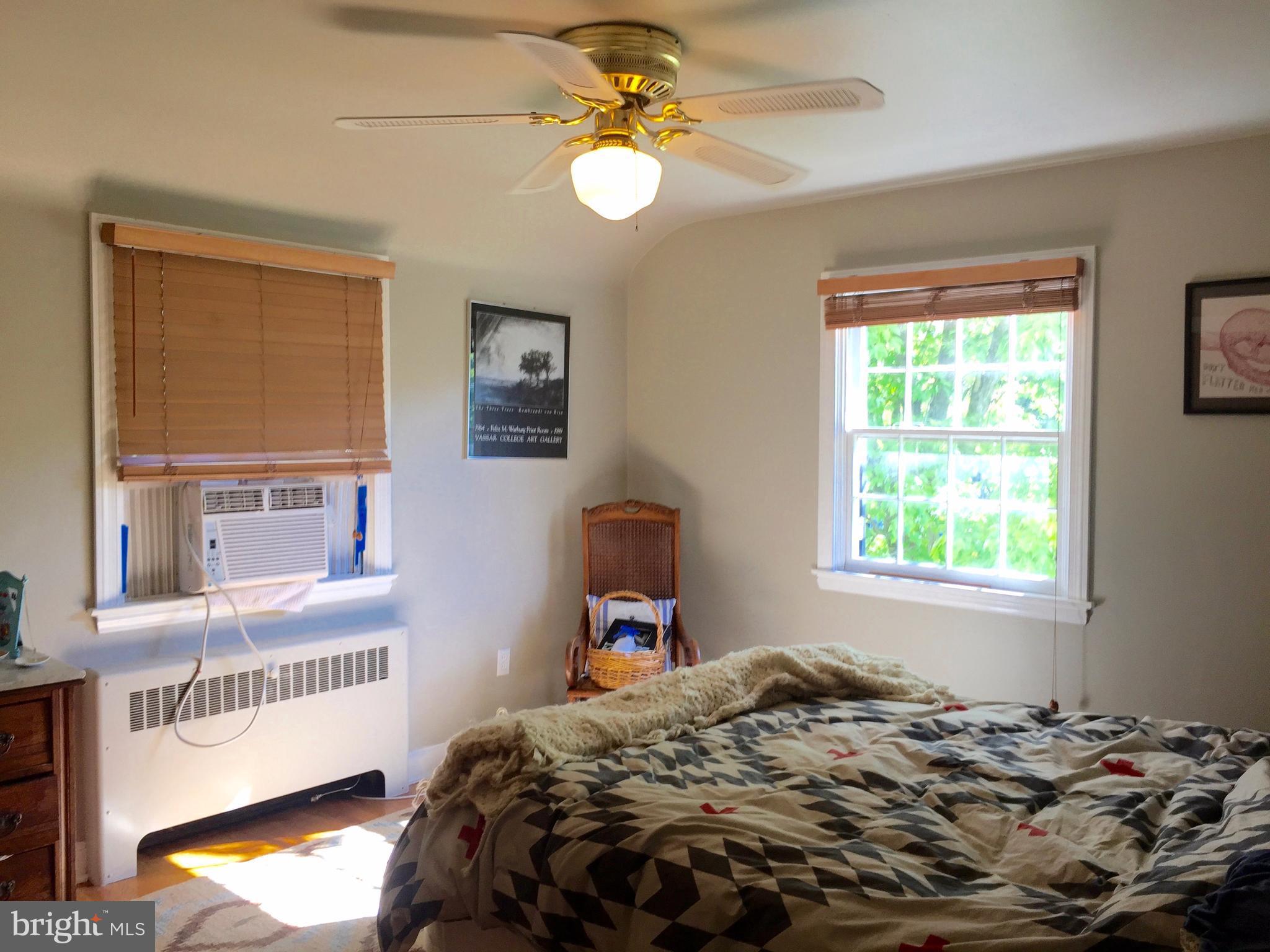 2444 Pickwick Road Baltimore, MD 21207 - Photo 17 of 24 a bedroom with a bed and a chandelier