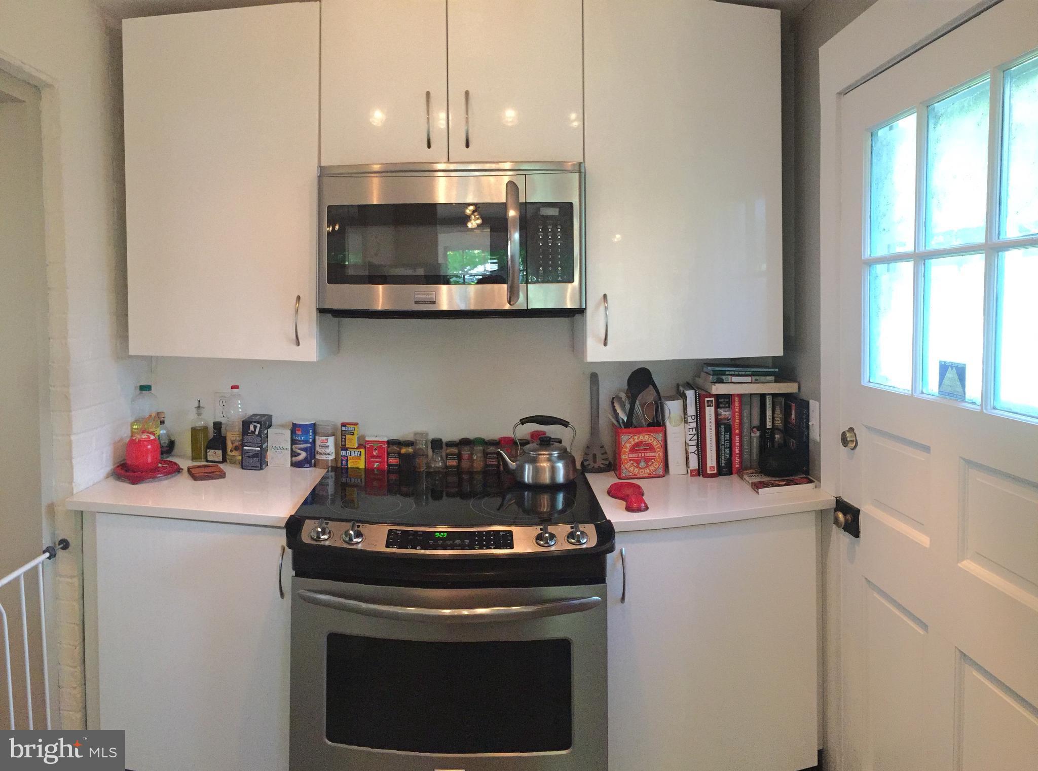 2444 Pickwick Road Baltimore, MD 21207 - Photo 5 of 24 a kitchen with stainless steel appliances granite countertop a sink and a stove