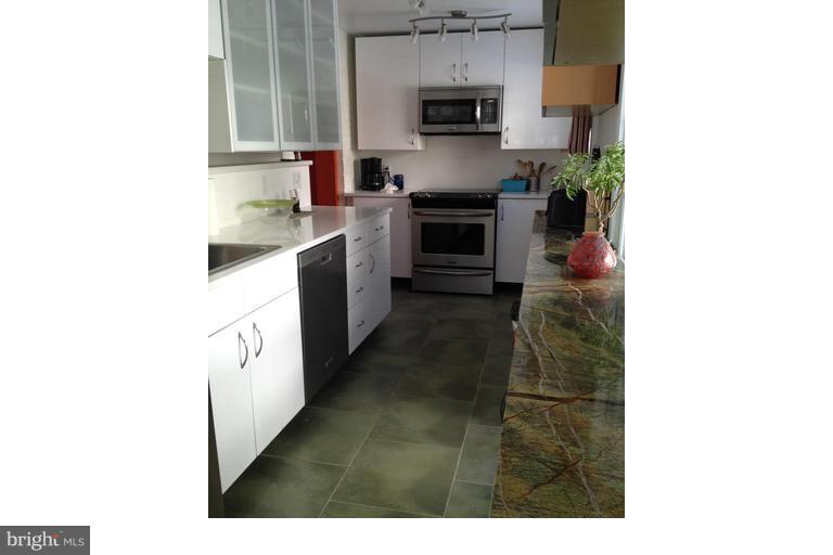 2444 Pickwick Road Baltimore, MD 21207 - Photo 6 of 24 a kitchen with stainless steel appliances a sink and a stove