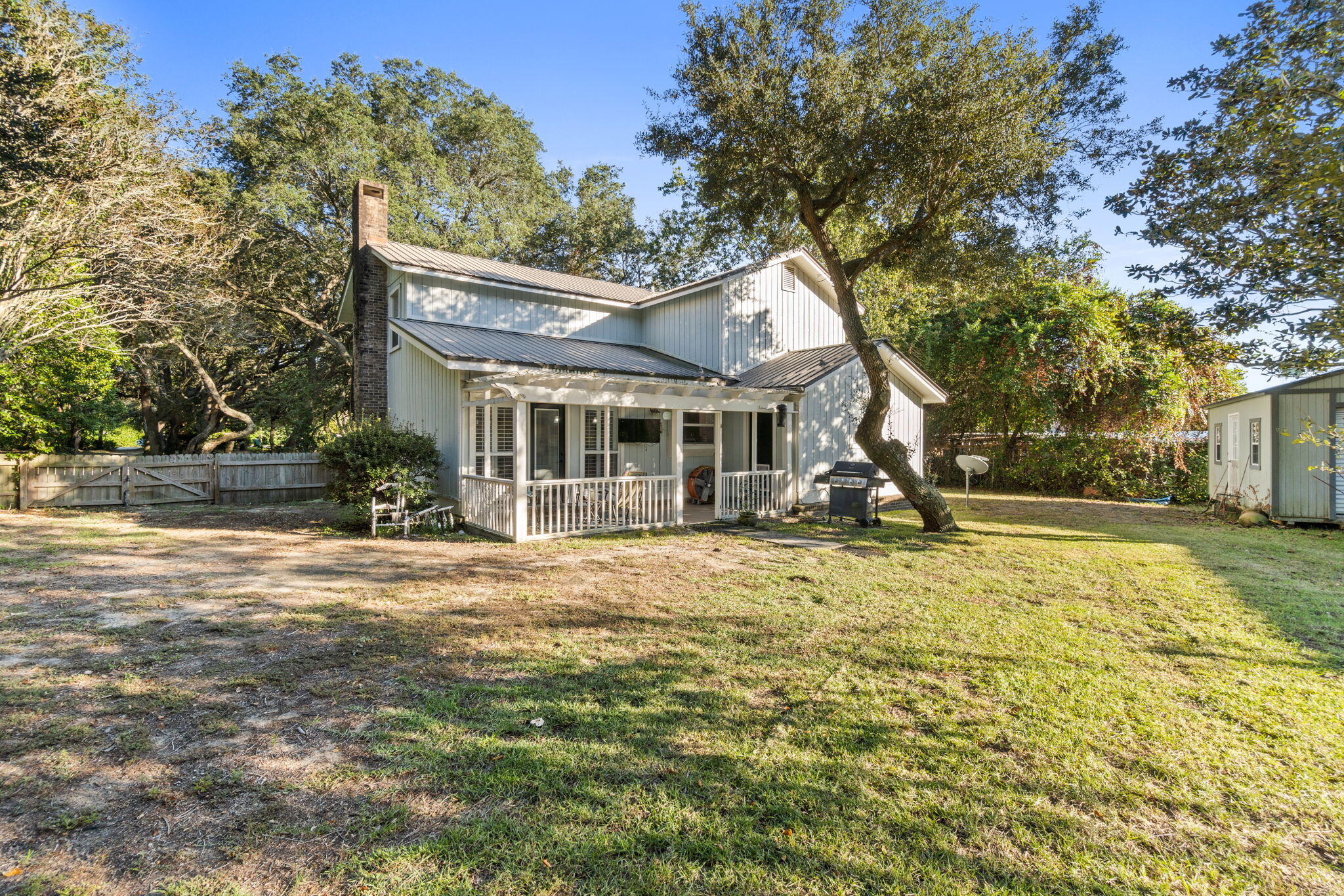 517 Main Street Destin, FL 32541 - Photo 2 of 14 a backyard of a house with table and chairs