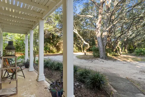 a view of a porch with chairs and table in the patio