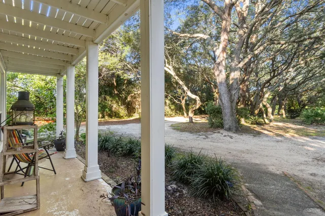 a view of a porch with chairs and table in the patio