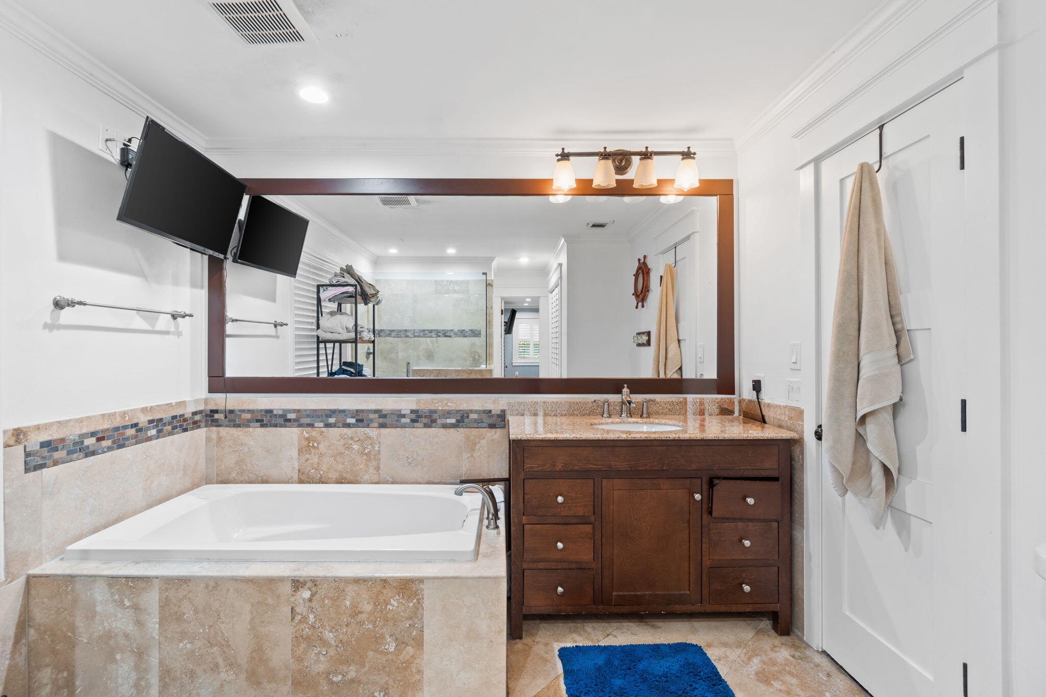 517 Main Street Destin, FL 32541 - Photo 7 of 14 a spacious bathroom with a granite countertop sink a mirror and a bathtub