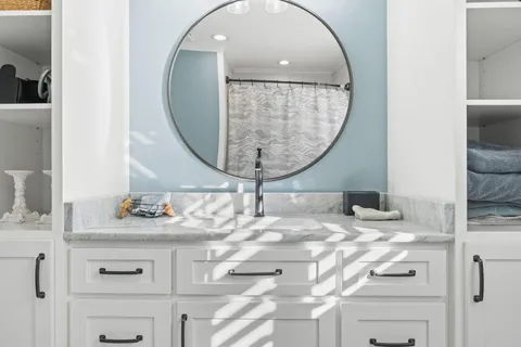 a kitchen with a stove cabinets and chairs