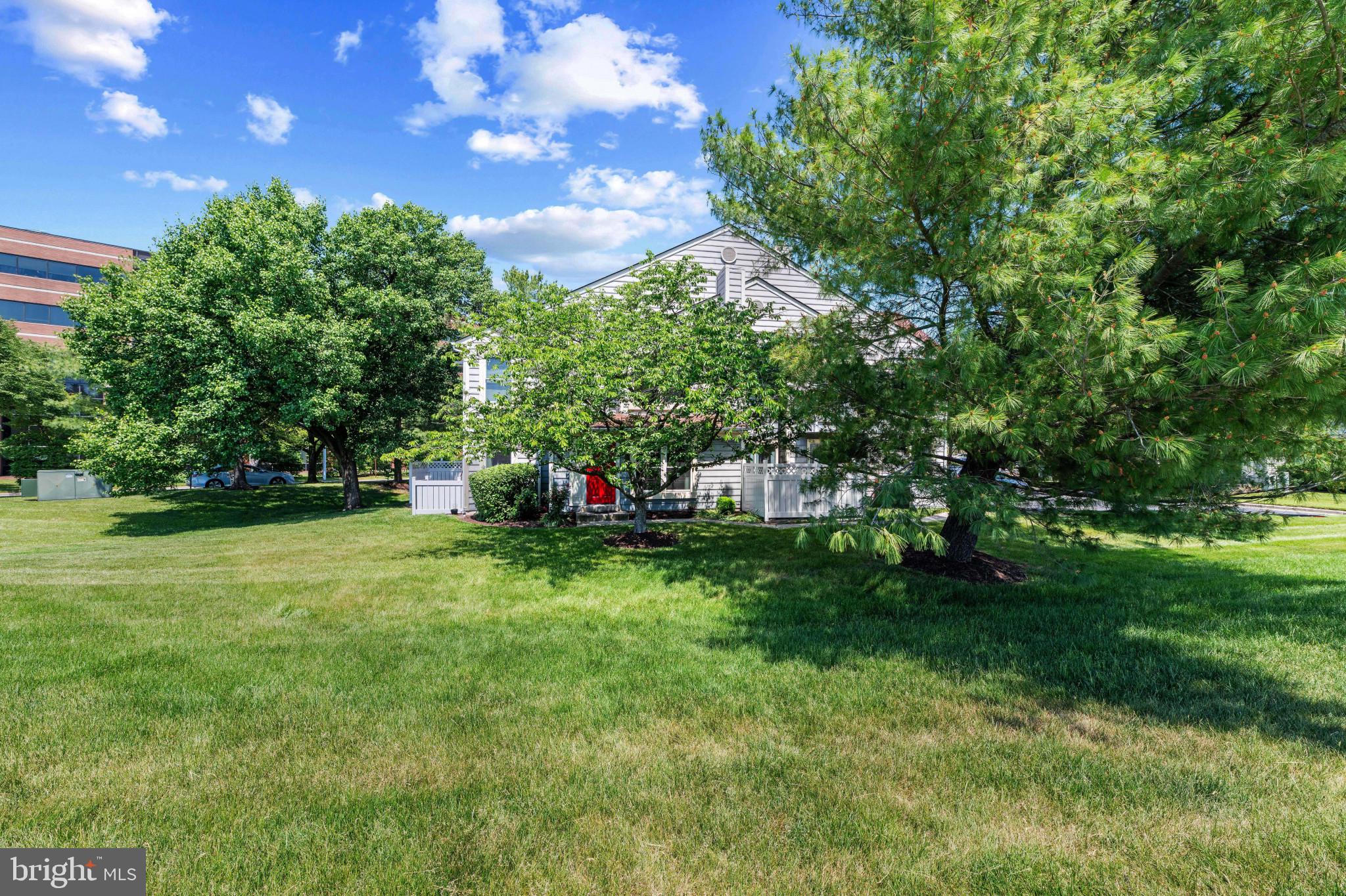 9302 Player Drive, Unit 155 Laurel, MD 20708 - Photo 43 of 43 a backyard of a house with lots of green space and fountain
