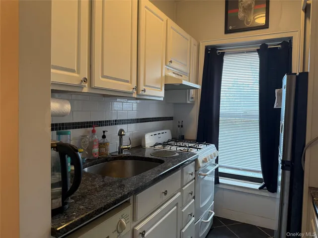 a kitchen with stainless steel appliances granite countertop a sink a stove and a granite counter tops